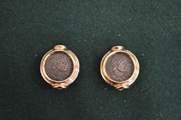 A pair of coin inset ear clips.