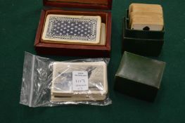 Two sets of playing cards and a group of cigarette cards.