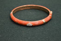 A pink enamel bangle.