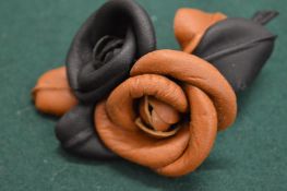 An unusual leather flower brooch, possibly Chanel.