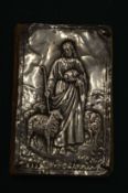 A prayer book with embossed silver cover.