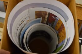 A group of unframed prints.