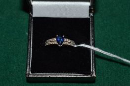 An 18ct white gold, diamond and sapphire ring.