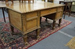 A 19th century pine pedestal desk with carved decoration.