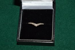 An 18ct gold and diamond bow shaped ring.