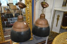 A pair of copper and painted copper large ceiling lights.