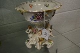 A Continental porcelain pedestal bowl or centrepiece, the bowl encrusted with flowers the base