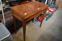 A mahogany card table.