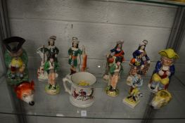 A group of Staffordshire figures and other items to include two toby jugs, fox head stirrup cup