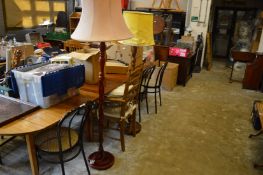 Four dining chairs and two standard lamps.