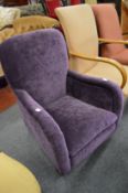 A small 1930's armchair upholstered with a plum colour velour.