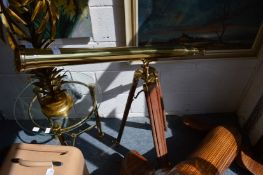 A brass telescope on stand.
