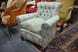 A button upholstered armchair.
