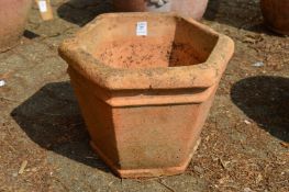 A hexagonal shaped terracotta plant pot.