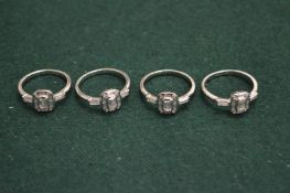 Four silver rings.