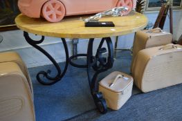A good circular marble top dining table with heavy wrought iron base.