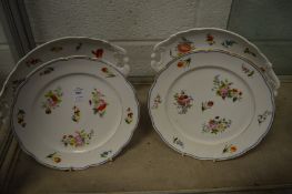 A pair of Vienna porcelain floral painted plates and a pair of Continental porcelain twin handled