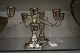 A pair of silver plated three light twin branch candelabra.