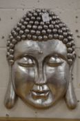 A silvered resin Buddha's head wall mask.