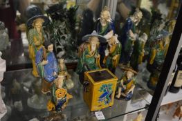 A group of Chinese sancai glazed figures and a jadeite group on stand.