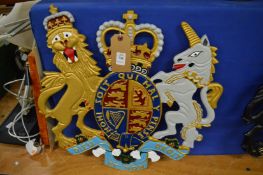 A painted cast metal coat of arms.