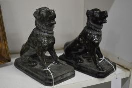 Two carved serpentine stone figures of dogs.