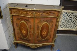A French ormolu mounted walnut and marquetry serpentine fronted two door cabinet (lacking marble