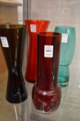 Four colourful glass vases.