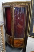 A French ormolu and mahogany bow fronted two door vitrine (one door unglazed).