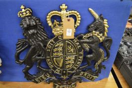 A painted cast metal coat of arms.