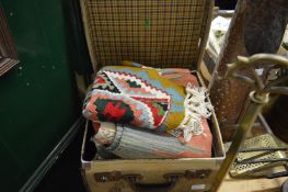 A small trunk containing three various carpets/wall hangings.