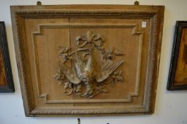 A carved oak panel depicting dead game.