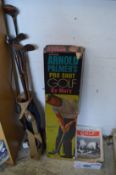 Old golf clubs, an Arnold Palmers Pro-shot golf game and other items.