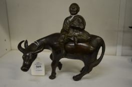 A Chinese bronze censer in the form of an ox and rider.