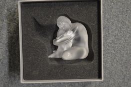 A Lalique glass figure of a seated female nude, boxed.