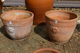 A large pair of terracotta plant pots.