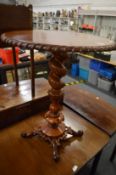 A mahogany occasional table with barley twist column support.