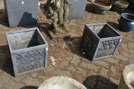 A pair of faux lead square shaped planters.