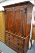 A Victorian mahogany linen press with a pair of panelled doors enclosing four sliding shelves, the
