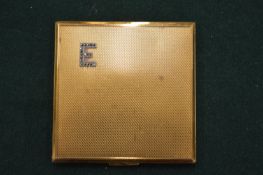 A gilt metal compact.