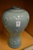 A Japanese celadon glazed vase.