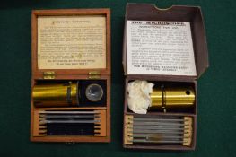 Two boxed miniature microscopes.