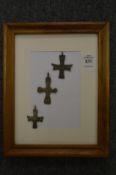 Small bronze crosses, framed and glazed.