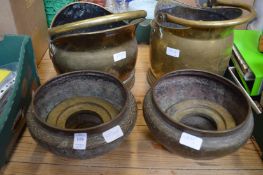 A pair of brass jardinieres and coal scuttles.