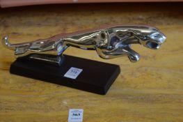 A reproduction chrome Jaguar car mascot on plinth base.