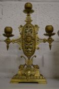 An ornate brass three light candelabra.