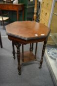 A Victorian walnut octagonal shaped two-tier occasional table.