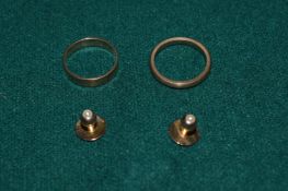 Two 18ct gold wedding bands and a pair of 18ct gold studs.