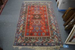 A Persian style carpet, red ground with geometric decoration, 170cm x 114cm.