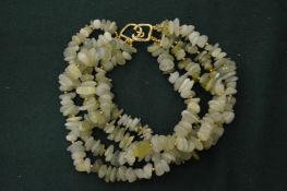 A Kenneth Lane jadeite bead necklace.